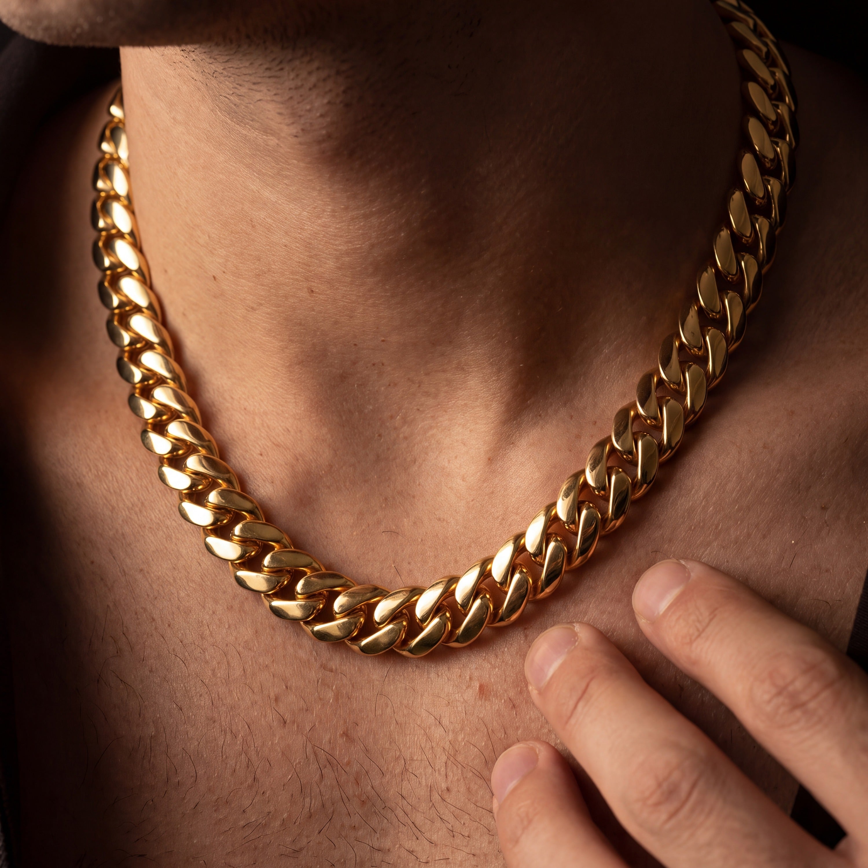 Gold Miami Cuban link chain worn open-necked, showing how the chain sits on the chest